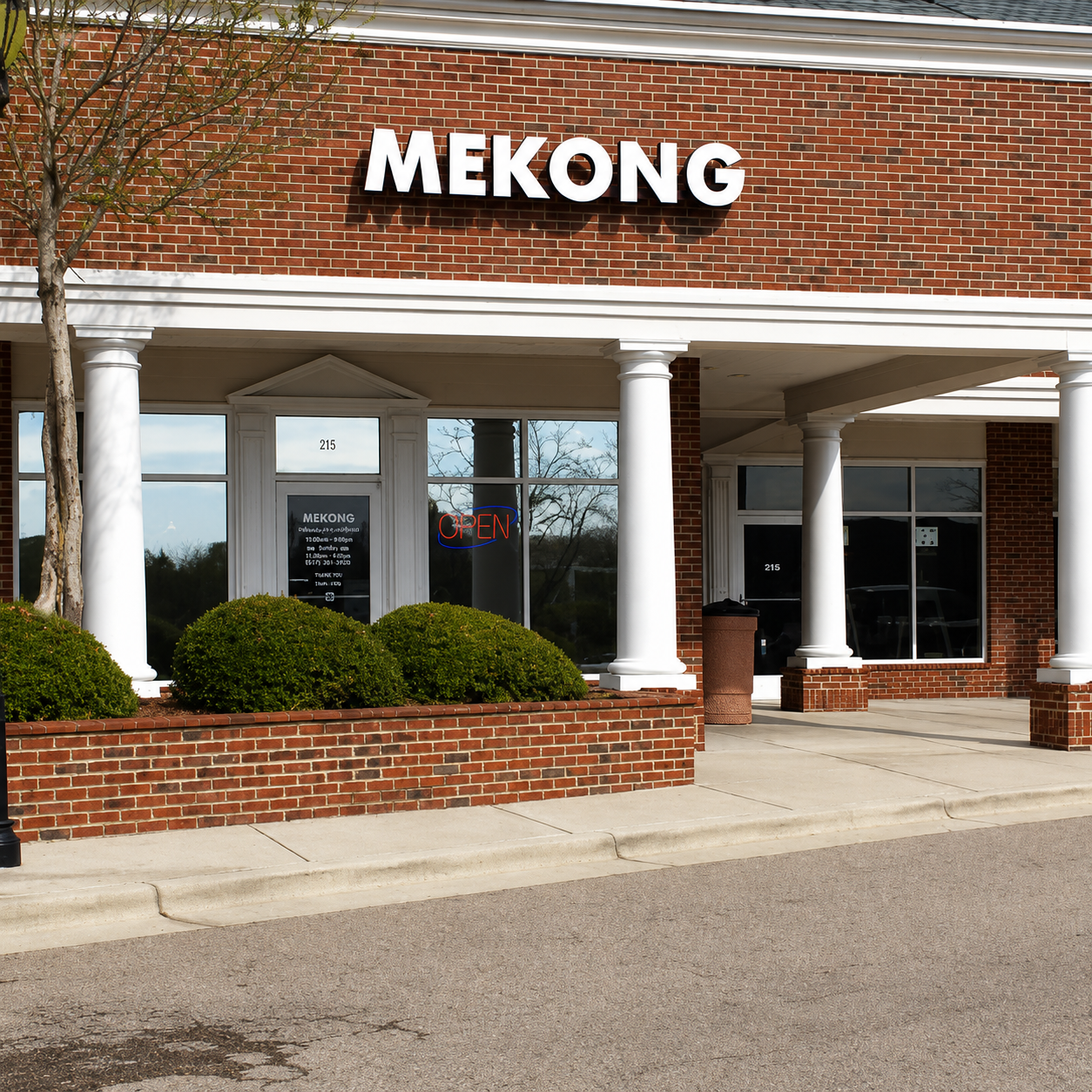 Front exterior of the restaurant with Mekong sign, windows, entryway, and landscaping along the sidewalk.