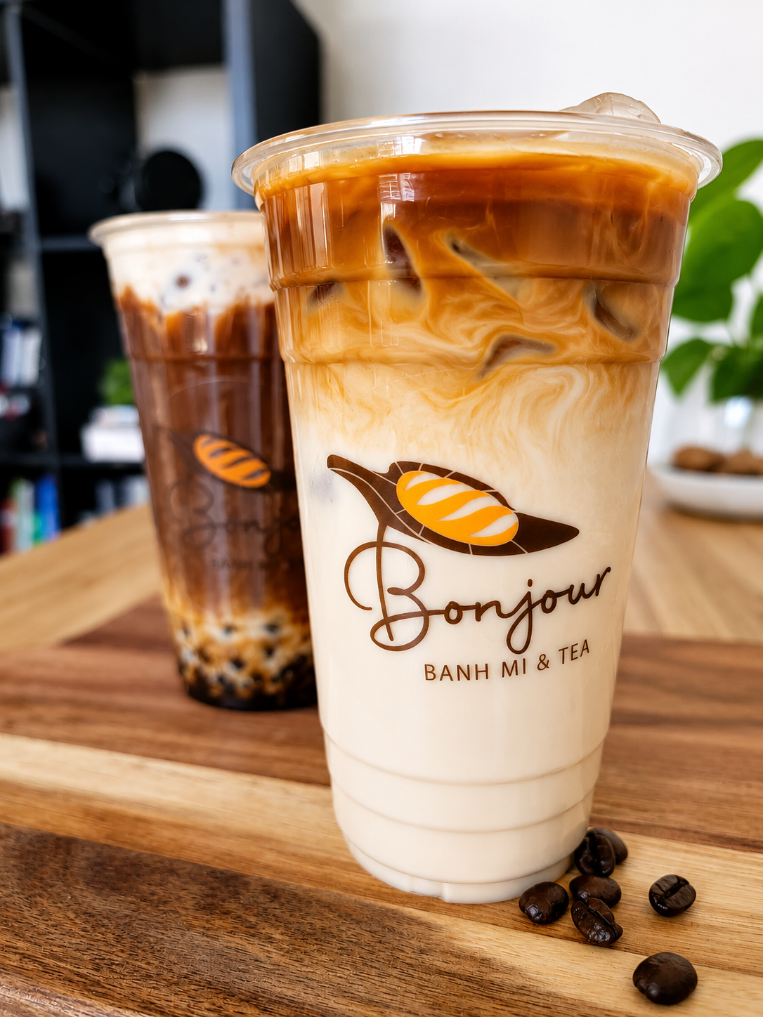 Vietnamese Coffee with rich dark coffee layered over sweet condensed milk in a clear iced cup.